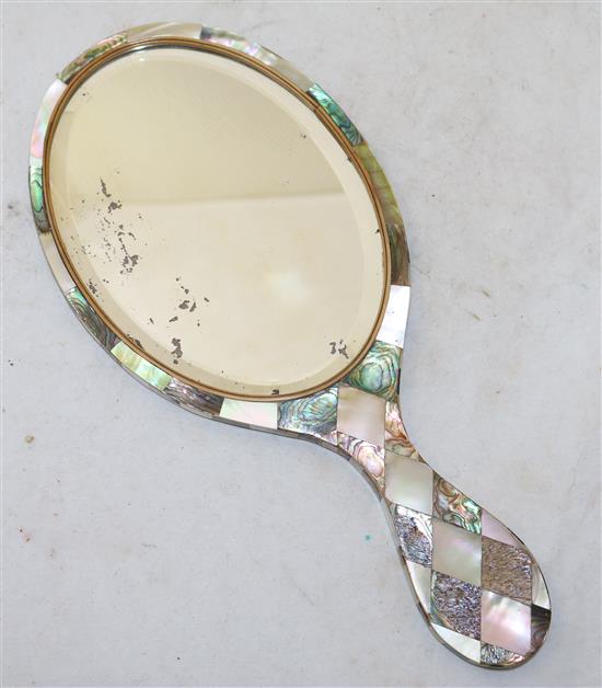 A Victorian hand mirror, completely veneered in Mother of Pearl